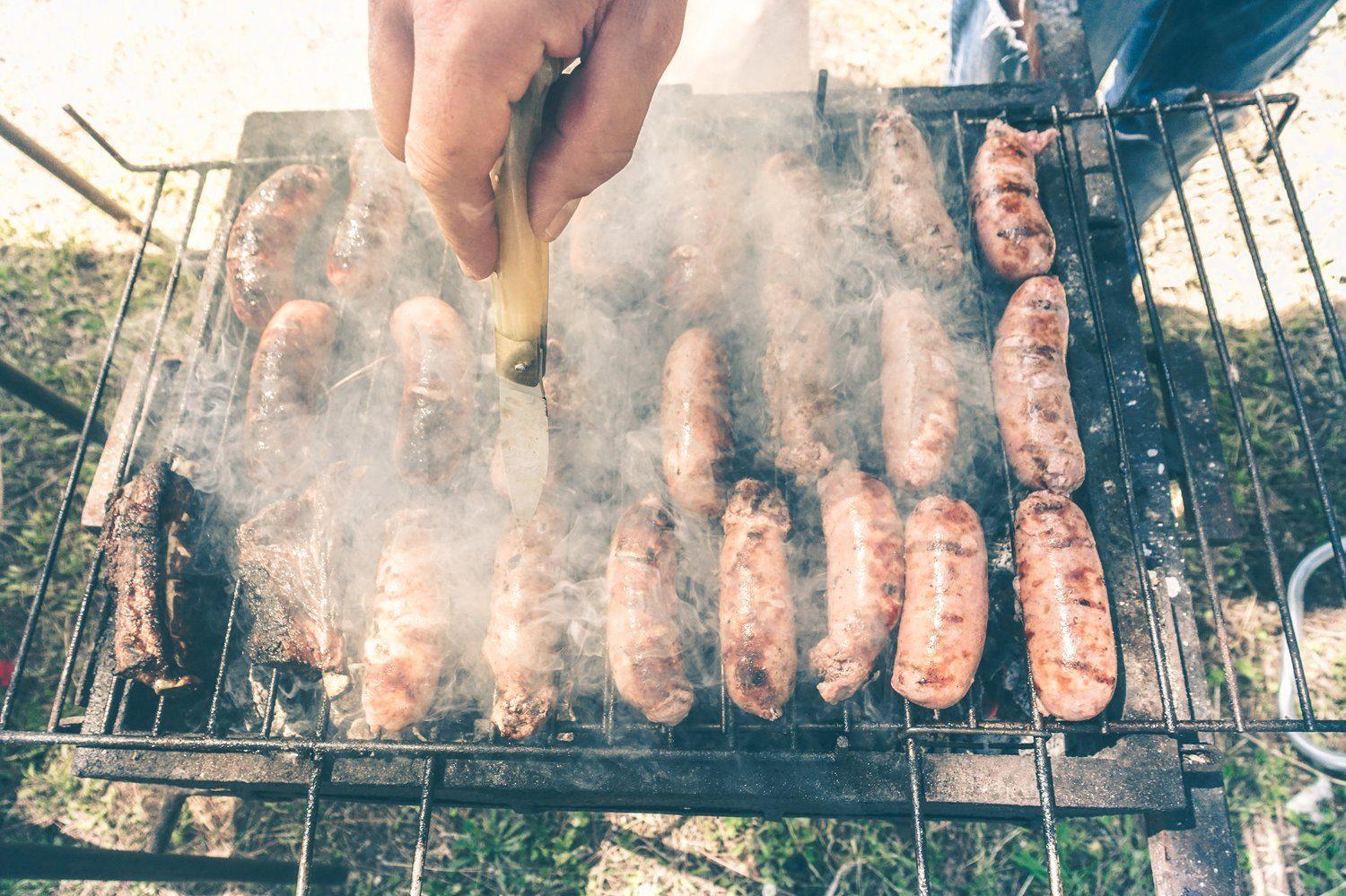 Grill z beczki i kiełbaski na ruszcie w letnie popołudnie